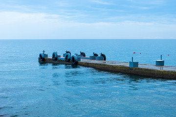 Seascape with a pier on the background of the water
