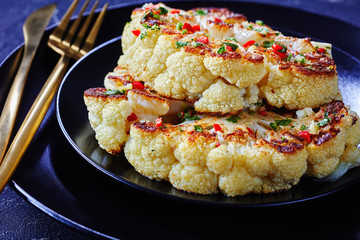 Vegetarian cauliflower steak on a black plate