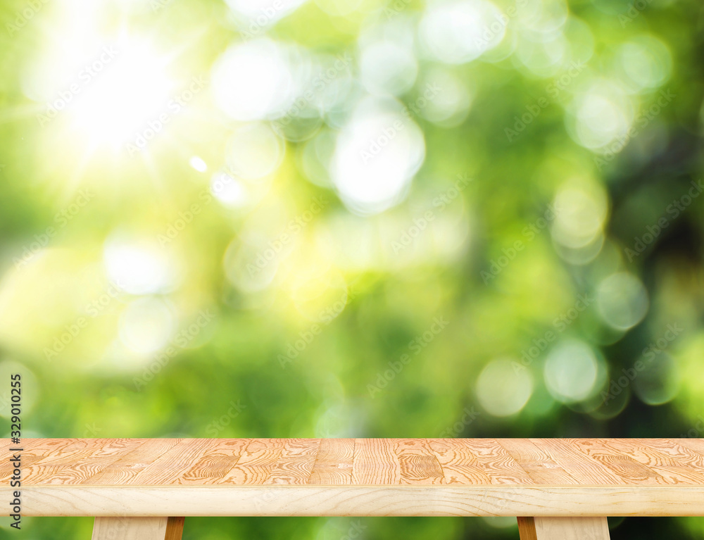 Poster Empty wood plank table top with blur tree in park with bokeh light at background,Mock up template for display of your design,Banner for advertise of product