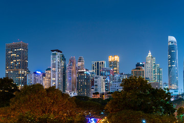 Cityscape of picturesque Bangkok at night time from rooftop. Panoramic evening skyline of the capital city of Thailand. The concept of metropolis.