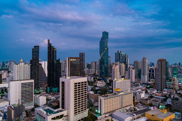 Obraz premium Aerial cityscape of picturesque Bangkok at sunset from rooftop view. Panoramic sunrise skyline of the biggest city in Thailand. The concept of metropolis.