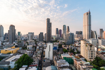 Fototapeta premium Aerial cityscape of picturesque Bangkok at sunset from rooftop view. Panoramic sunrise skyline of the biggest city in Thailand. The concept of metropolis.