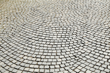 Abstract background of old cobblestone pavement close-up