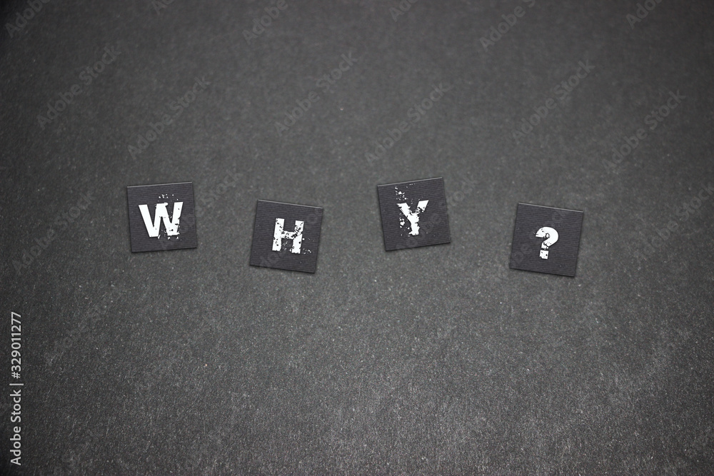 Fototapete close up of scratched letters that spell out why with question mark on .black paper background