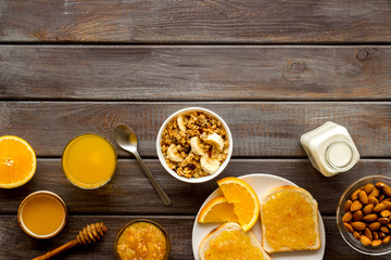 Fototapeta na wymiar Vegetarian breakfast with granola and fruits on wooden background top-down frame copy space