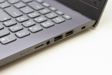 Close up of silver laptop connectors on a white background