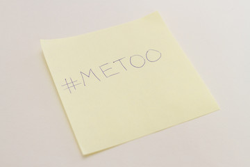 Yellow sticker of paper with hand drawn text 