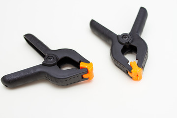 Two black plastic clamps. Equipment for handicraft, construction and photography.
