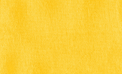 Vibrant yellow texture of binding fabric. Yellow textile background with natural folds. Close-up