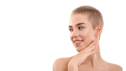 Healthy skin. Portrait of a beautiful smiling blond woman with short hair and nude make up touching...