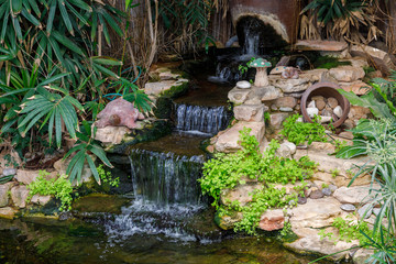 Small decorative waterfall with various decorations