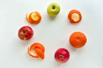 Bowl of healthy fresh fruit salad on wooden background. Top view. Citrus fruits on a white background. Oranges, tangerines, apples.