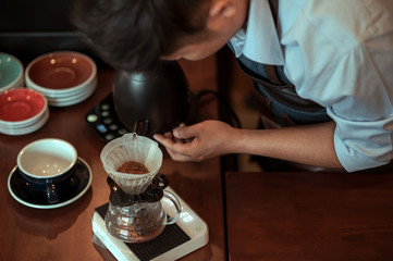 The Barista dripping roasted coffee