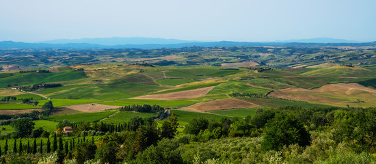 Traditional countryside and landscapes of beautiful Tuscany. Fields in golden colors and cypresses. Holiday, traveling concept. Agro tour of Europe.