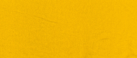 Vibrant yellow texture of binding fabric. Yellow textile background with natural folds. Close-up - 329016012