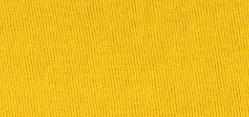 Vibrant yellow texture of binding fabric. Yellow textile background with natural folds. Close-up
