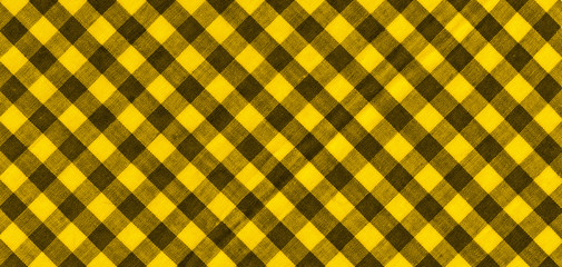 The texture of the bright yellow of binding gingham fabric. Yellow textile background. Fabric...