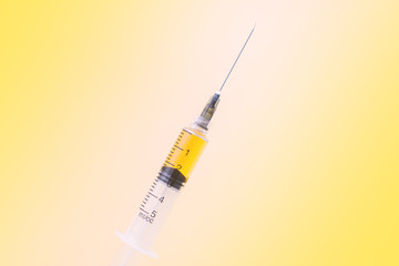 concept of new medicine. yellow syringe.