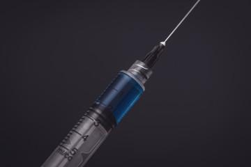 syringe on black background