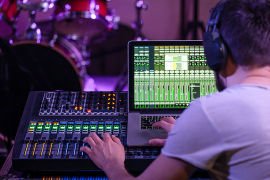 Digital mixer in a recording Studio , with a computer for recording music. On the background of the sound engineer at work.