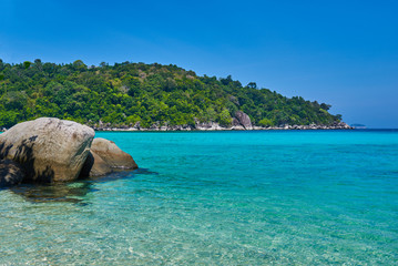 Fototapeta premium Tropical paradise beach with white sand and blue sky turquoise water and granite rocks travel tourism background concept. Amazing tropical holidays in paradise beaches of Tioman island, Malaysia.