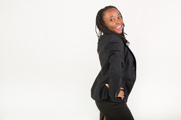 Naklejka na ściany i meble beautiful young african woman in a black suit on a white background