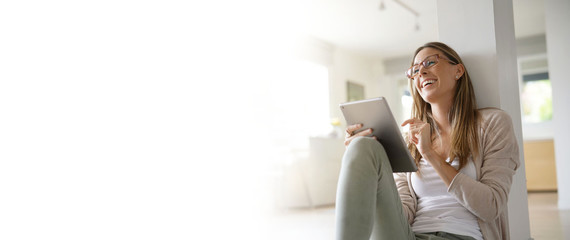 Template woman at home relaxing and websurfing with digital tablet
