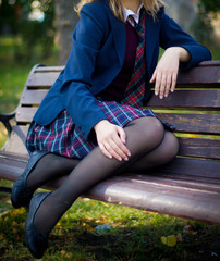 Girl student sitting on a bench