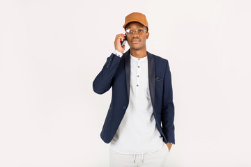 handsome young african man with a phone in his hand on a white background