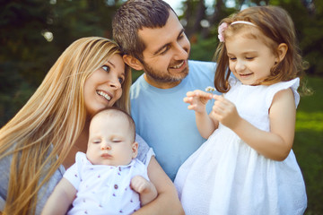 Mother father and children funny laughing outside