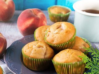 Vegan eggs free spelt wheat muffins with peaches and apples in green paper cases on checkered napkin
