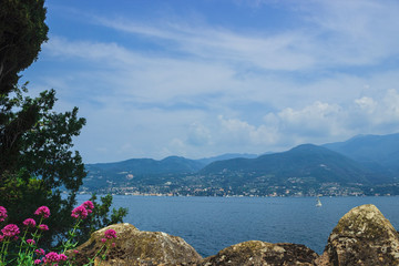 Beautiful view of lake Garda and the coastal mountains. Italy. Soft focus, blurry background.