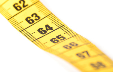 Close-up of a yellow measuring tape isolated on white - 64