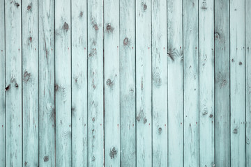 Old blue wooden fence. Weathered texture with peeling paint.