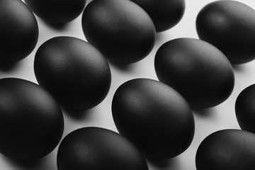 Pattern of black easter eggs on white background. Easter minimalistic concept