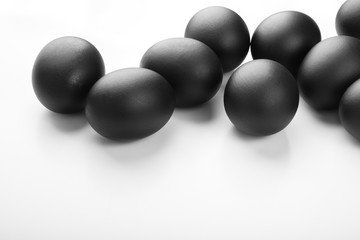 Composition of black easter eggs on a white background. Easter minimalistic concept