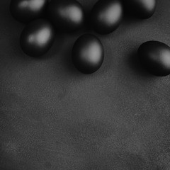 Black eggs on a black background. Easter minimalistic concept