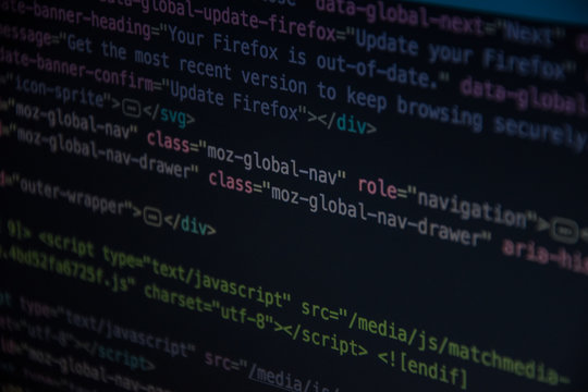 Close up css HTML code on monitor screen with black background