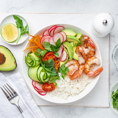Avocado, prawn, cucumber, tomato, radish, carrot and rice salad bowl. Healthy food.