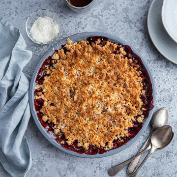 berry crumble pie in grey baking dish
