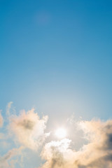 Fototapeta na wymiar Bright clouds and sun in blue sky in clearly da in summer.