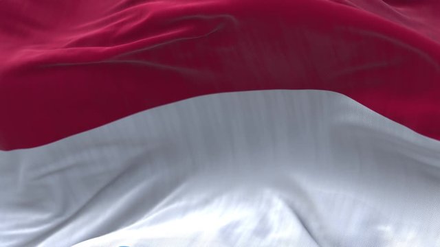 4k Monaco National flag slow loop seamless waving with visible wrinkles in wind blue sky background.A fully digital rendering;animation loops at 20 seconds.