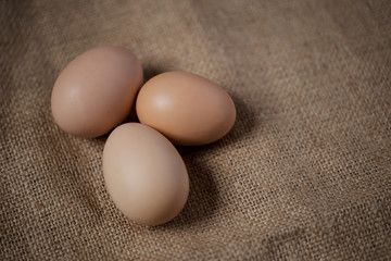 Beautiful brown yellow eggs on the brown cloth