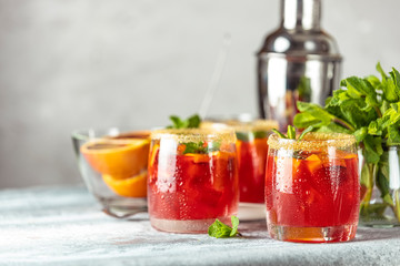 Italian aperol spritz cocktail with orange slices and ingredients on light gray stone table. Milano...