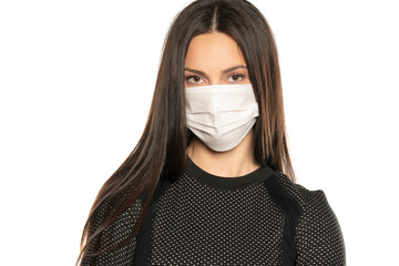 Beautiful young woman with protective mask on her face