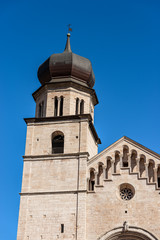 Fototapeta na wymiar Closeup of San Vigilio Cathedral (Duomo di Trento, 1212-1321) with the bell tower and facade in Romanesque style, Trento downtown, Trentino-Alto Adige, Italy, Europe