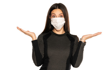 Beautiful advertizing young woman with protective mask on her face on white background