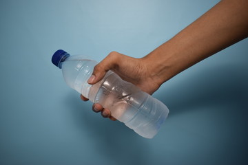 Man Holding Plastic Bottle Water Isolated On Clear Blue Background