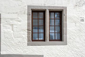 Fototapeta na wymiar Window in the wall of an old stone building