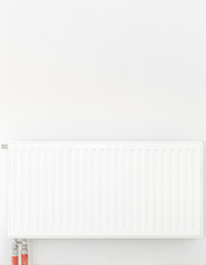 Radiator in front of a white wall. Space for text.
